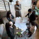 A team of professionals engage in a business meeting in a sleek, modern office setting.