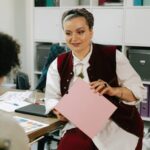 Professional women discussing a project in an office setting.