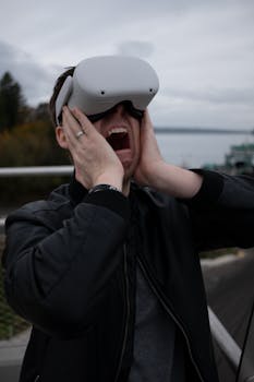 A man outdoors expresses intense emotion while using VR goggles, capturing the thrill of virtual reality.