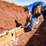 Male construction worker building a foundation outdoors in Londrina, Brazil.