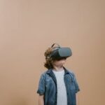 Young boy wearing VR headset, immersed in virtual reality experience indoors.